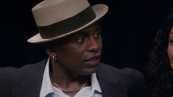 Movie still from “Meet the Browns” (2008), directed by Tyler Perry – A person wearing a suit and a hat; Close Up shot, High angle