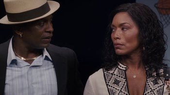 Movie still from “Meet the Browns” (2008), directed by Tyler Perry – A man and a woman standing next to each other in front of a black background; Close Up shot, Over the shoulder angle
