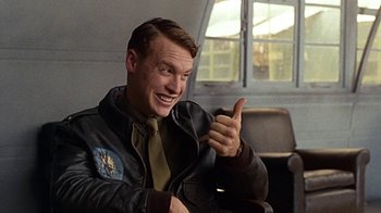 Movie still from “Memphis Belle” (1990), directed by Michael Caton-Jones – A man giving a thumbs up while wearing a leather jacket; Close Up shot, Low angle