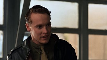Movie still from “Memphis Belle” (1990), directed by Michael Caton-Jones – A young man wearing a leather jacket and a tie; Close Up shot, Over the shoulder angle