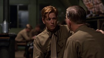 Movie still from “Memphis Belle” (1990), directed by Michael Caton-Jones – A man wearing a neck tie talking to another man; Close Up shot, Over the shoulder angle