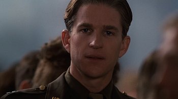 Movie still from “Memphis Belle” (1990), directed by Michael Caton-Jones – A person wearing a military uniform; Close Up shot, Over the shoulder angle