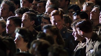 Movie still from “Memphis Belle” (1990), directed by Michael Caton-Jones – A group of people that are standing in a room; Medium shot, High angle