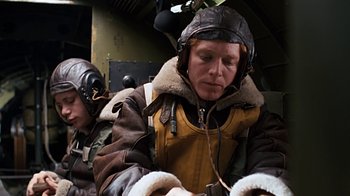 Movie still from “Memphis Belle” (1990), directed by Michael Caton-Jones – A man in a bomber jacket and a helmet; Medium shot, Low angle