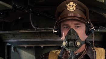 Movie still from “Memphis Belle” (1990), directed by Michael Caton-Jones – A man in a military uniform with a gas mask on; Close Up shot, Low angle