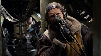 Movie still from “Memphis Belle” (1990), directed by Michael Caton-Jones – A man in a bomber jacket and a leather hat; Medium shot, Low angle