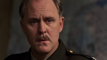 Movie still from “Memphis Belle” (1990), directed by Michael Caton-Jones – A person wearing a uniform; Close Up shot, Low angle