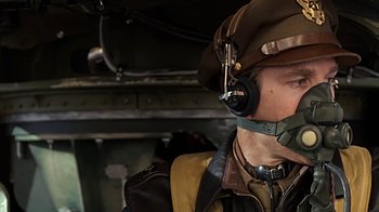 Movie still from “Memphis Belle” (1990), directed by Michael Caton-Jones – A man wearing a hat and a headset; Close Up shot, Low angle