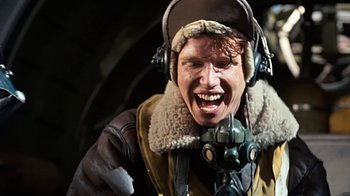 Movie still from “Memphis Belle” (1990), directed by Michael Caton-Jones – A man wearing a helmet and ear muffs; Close Up shot, Overhead angle