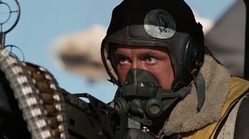 Movie still from “Memphis Belle” (1990), directed by Michael Caton-Jones – A person wearing a gas mask; Close Up shot, Low angle