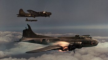 Movie still from “Memphis Belle” (1990), directed by Michael Caton-Jones – A group of planes flying in the sky; Wide shot, Low angle