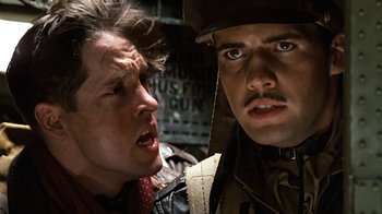 Movie still from “Memphis Belle” (1990), directed by Michael Caton-Jones – Two men are standing next to each other; Close Up shot, Low angle