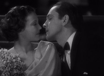 Movie still from “Merrily We Go to Hell” (1932), directed by Dorothy Arzner – A man and a woman are kissing in a car; Close Up shot, Low angle