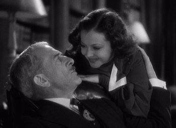 Movie still from “Merrily We Go to Hell” (1932), directed by Dorothy Arzner – An old photo of a man and a young woman; Close Up shot, High angle