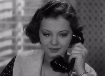 Movie still from “Merrily We Go to Hell” (1932), directed by Dorothy Arzner – A woman talking on a phone while sitting down; Close Up shot, High angle