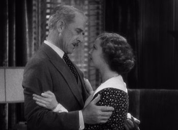 Movie still from “Merrily We Go to Hell” (1932), directed by Dorothy Arzner – An older man and a younger woman embracing each other; Medium shot, High angle