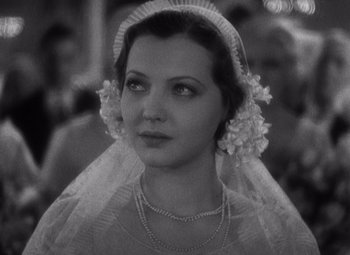 Movie still from “Merrily We Go to Hell” (1932), directed by Dorothy Arzner – A black - and - white photo of a woman wearing a veil; Close Up shot, High angle
