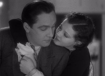 Movie still from “Merrily We Go to Hell” (1932), directed by Dorothy Arzner – A man and a woman embracing each other in black and white; Close Up shot, Low angle
