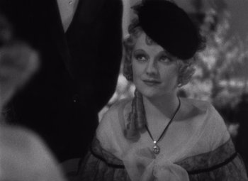 Movie still from “Merrily We Go to Hell” (1932), directed by Dorothy Arzner – An old photo of a woman wearing a hat; Close Up shot, High angle