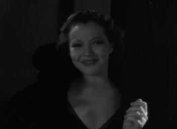 Movie still from “Merrily We Go to Hell” (1932), directed by Dorothy Arzner – A black - and - white photo of a woman smiling; Close Up shot, High angle