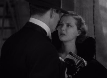 Movie still from “Merrily We Go to Hell” (1932), directed by Dorothy Arzner – A man and a woman are looking at each other; Close Up shot, Low angle