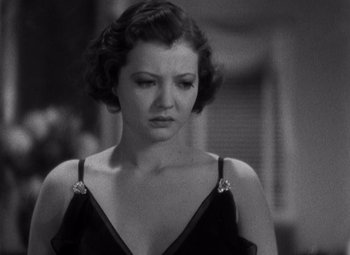 Movie still from “Merrily We Go to Hell” (1932), directed by Dorothy Arzner – An old photo of a woman in a black dress; Close Up shot, High angle