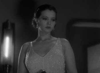 Movie still from “Merrily We Go to Hell” (1932), directed by Dorothy Arzner – A black and white photo of a woman in a dress; Close Up shot, Low angle
