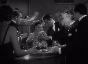 Movie still from “Merrily We Go to Hell” (1932), directed by Dorothy Arzner – A black and white photo of people at a bar; Medium shot, High angle
