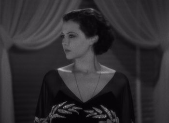 Movie still from “Merrily We Go to Hell” (1932), directed by Dorothy Arzner – A black and white photo of a woman in a black dress; Close Up shot, Low angle