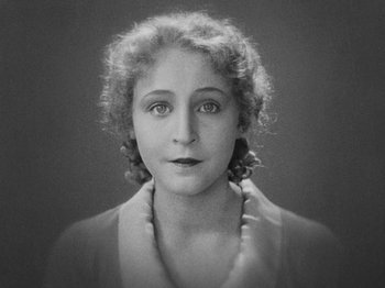 Movie still from “Metropolis” (1927), directed by Fritz Lang – An old black and white photo of a young woman; Close Up shot, High angle