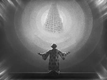 Movie still from “Metropolis” (1927), directed by Fritz Lang – A man in a clown suit standing in front of a skyscraper; Extreme Wide shot, Low angle