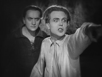 Movie still from “Metropolis” (1927), directed by Fritz Lang – Two men are standing in front of each other; Medium shot, Low angle