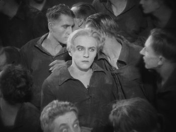 Movie still from “Metropolis” (1927), directed by Fritz Lang – Black and white photograph of a group of men; Medium shot, High angle