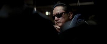 Movie still from “Michael Clayton” (2007), directed by Tony Gilroy – A person wearing sunglasses; Close Up shot, Low angle