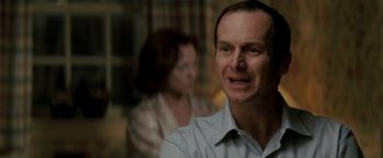 Movie still from “Michael Clayton” (2007), directed by Tony Gilroy – A person sitting in front of another person; Close Up shot, Over the shoulder angle