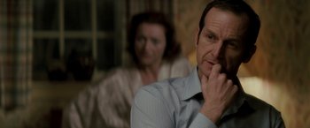 Movie still from “Michael Clayton” (2007), directed by Tony Gilroy – A man and a woman sitting next to each other in a room; Close Up shot, Over the shoulder angle