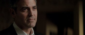 Movie still from “Michael Clayton” (2007), directed by Tony Gilroy – A person wearing a suit and tie; Close Up shot, Low angle
