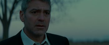 Movie still from “Michael Clayton” (2007), directed by Tony Gilroy – A person wearing a suit and tie; Close Up shot, Low angle