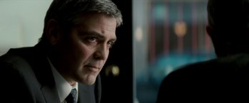 Movie still from “Michael Clayton” (2007), directed by Tony Gilroy – A person wearing a suit and tie; Close Up shot, Over the shoulder angle