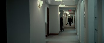 Movie still from “Michael Clayton” (2007), directed by Tony Gilroy – Two people are walking down a hallway in a building; Extreme Wide shot, Over the shoulder angle