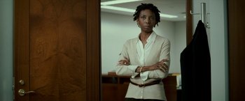Movie still from “Michael Clayton” (2007), directed by Tony Gilroy – A woman standing in front of a mirror in a room; Medium shot, Low angle