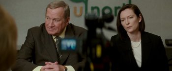 Movie still from “Michael Clayton” (2007), directed by Tony Gilroy – A man and a woman in suits and ties; Close Up shot, Over the shoulder angle