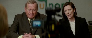 Movie still from “Michael Clayton” (2007), directed by Tony Gilroy – A man and a woman in suits and ties; Medium shot, Over the shoulder angle