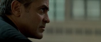 Movie still from “Michael Clayton” (2007), directed by Tony Gilroy – A man's face with a blurry background; Close Up shot, Over the shoulder angle
