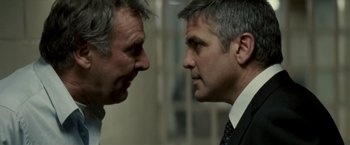 Movie still from “Michael Clayton” (2007), directed by Tony Gilroy – Two men in business suits face each other; Close Up shot, Over the shoulder angle