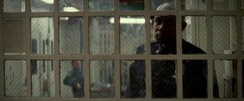 Movie still from “Michael Clayton” (2007), directed by Tony Gilroy – A man looking out of a jail cell through a window; Close Up shot, Over the shoulder angle