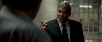 Movie still from “Michael Clayton” (2007), directed by Tony Gilroy – A man wearing a suit and tie holding a toothbrush; Close Up shot, Over the shoulder angle