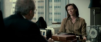 Movie still from “Michael Clayton” (2007), directed by Tony Gilroy – Two people sitting at a table with a laptop; Medium shot, Over the shoulder angle