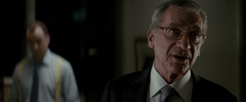 Movie still from “Michael Clayton” (2007), directed by Tony Gilroy – An older man wearing a suit and tie; Close Up shot, Over the shoulder angle