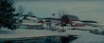 Movie still from “Michael Clayton” (2007), directed by Tony Gilroy – A red barn sitting in the middle of a snow covered field; Extreme Wide shot, High angle
